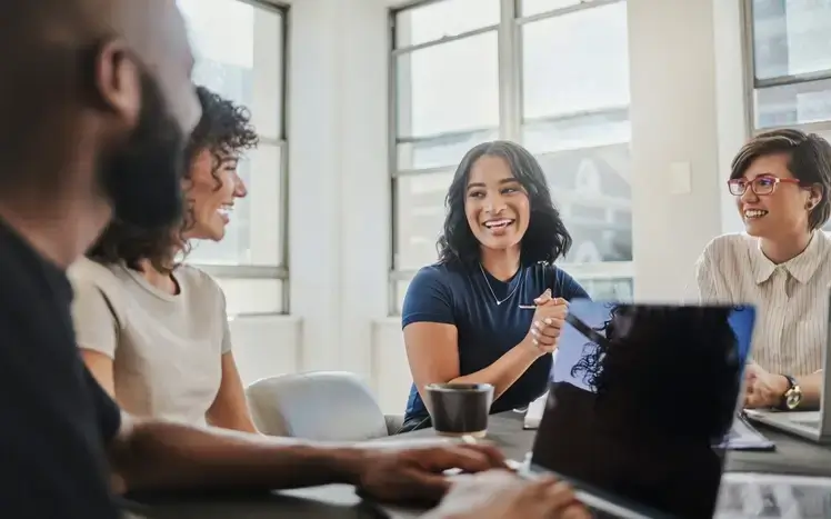 people smiling and talking at work