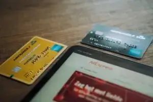 AmEx card beside laptop computer
