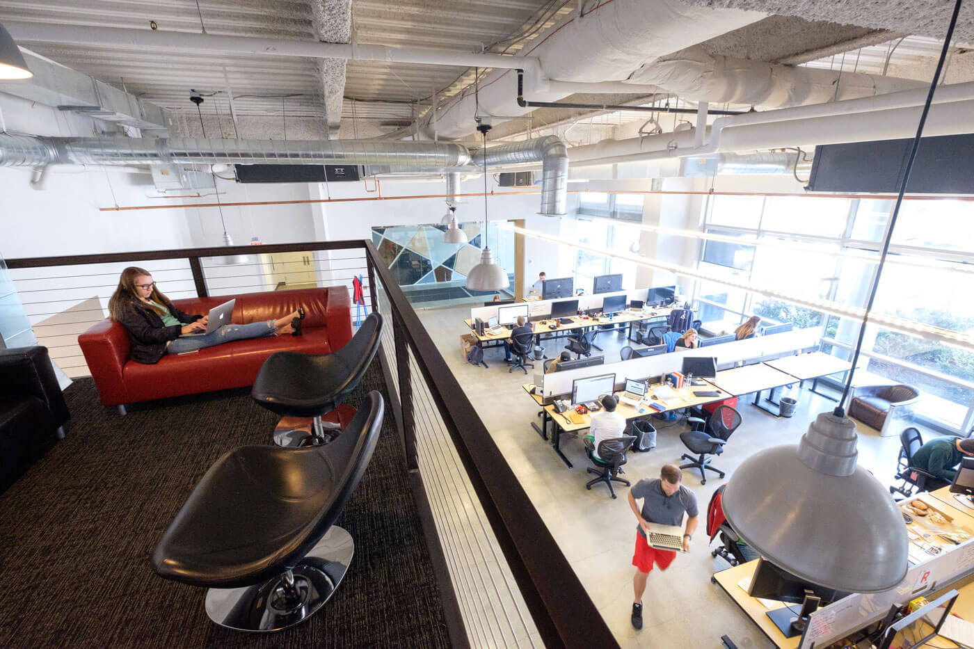 A catwalk above the work area doubles as a quiet workspace