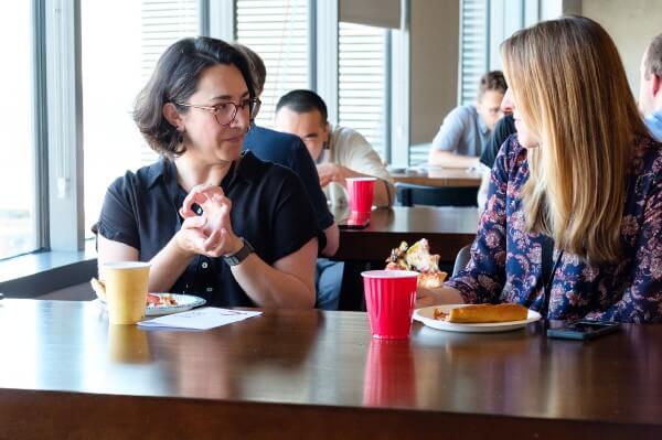 employees chatting over pizza