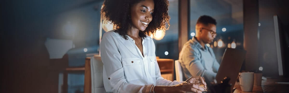 Smiling woman working at computer in office
