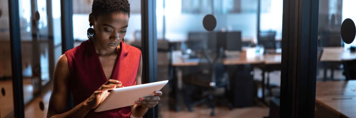 Woman in office looking at tablet