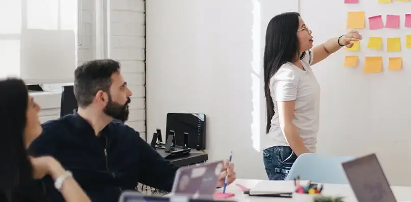 People looking at whiteboard at work