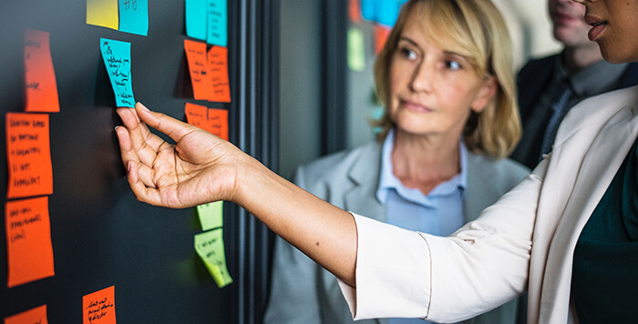 Colleagues working together with post-its