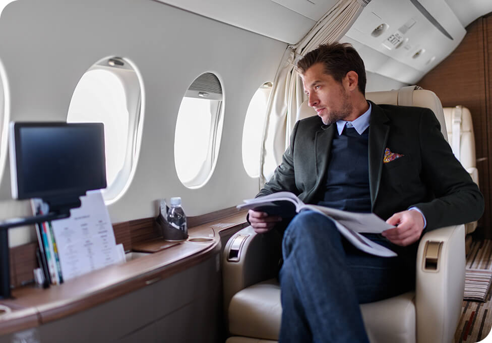 Man reading a newspaper in first class