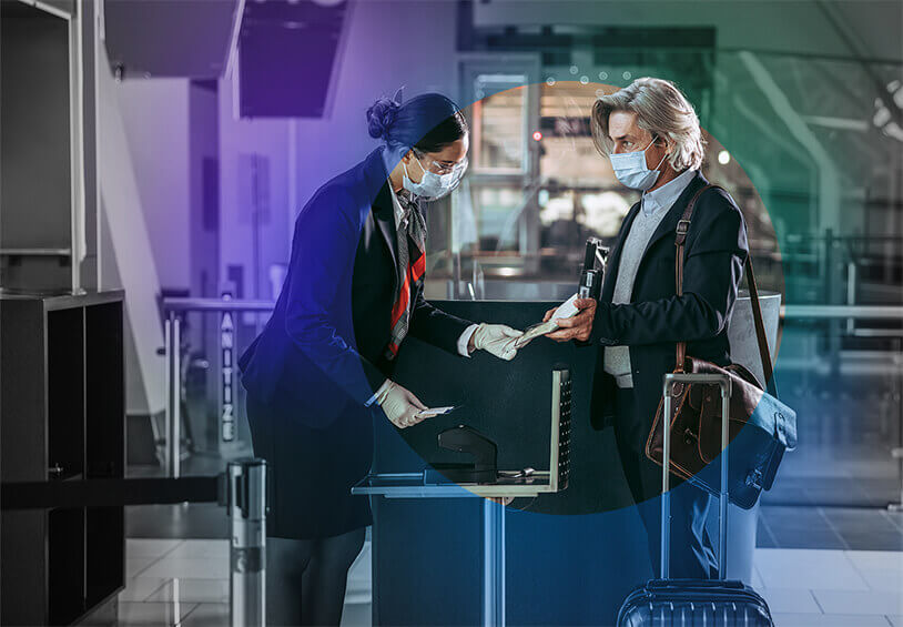 Image of airport associate looking a passenger's ticket