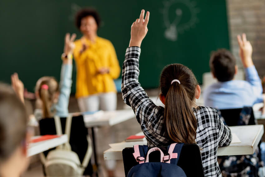 students raising hands