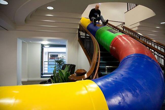 Man on slide at google workplace