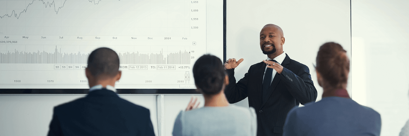 A man presenting to a diverse group of people