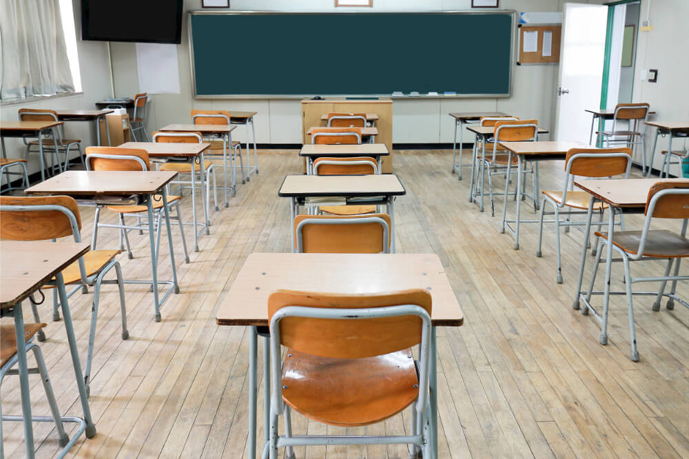 Dramatic image of a classroom with empty chairs