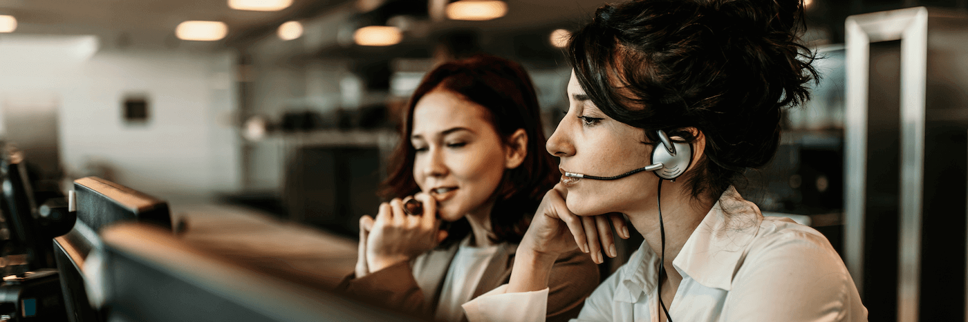 Two women working in a contact center