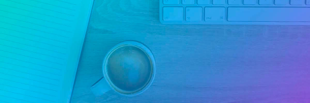 A woman drinking coffee at her computer