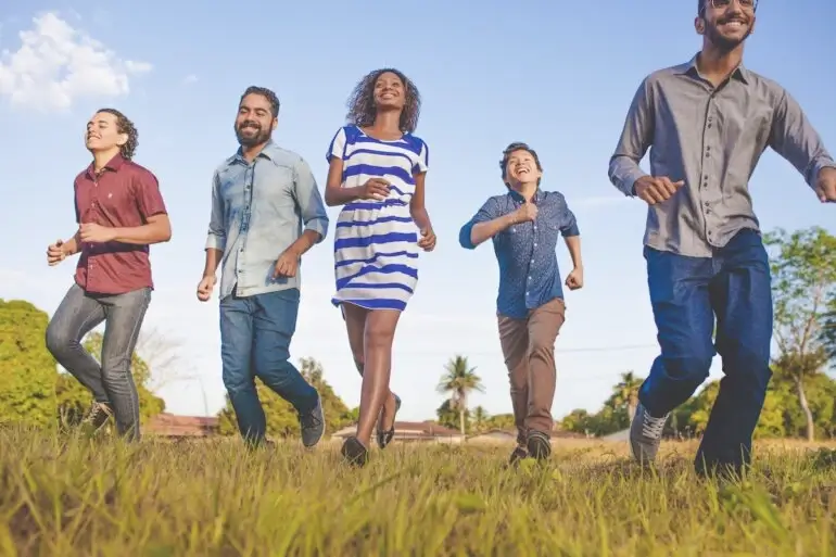 Employees happy running in a field 