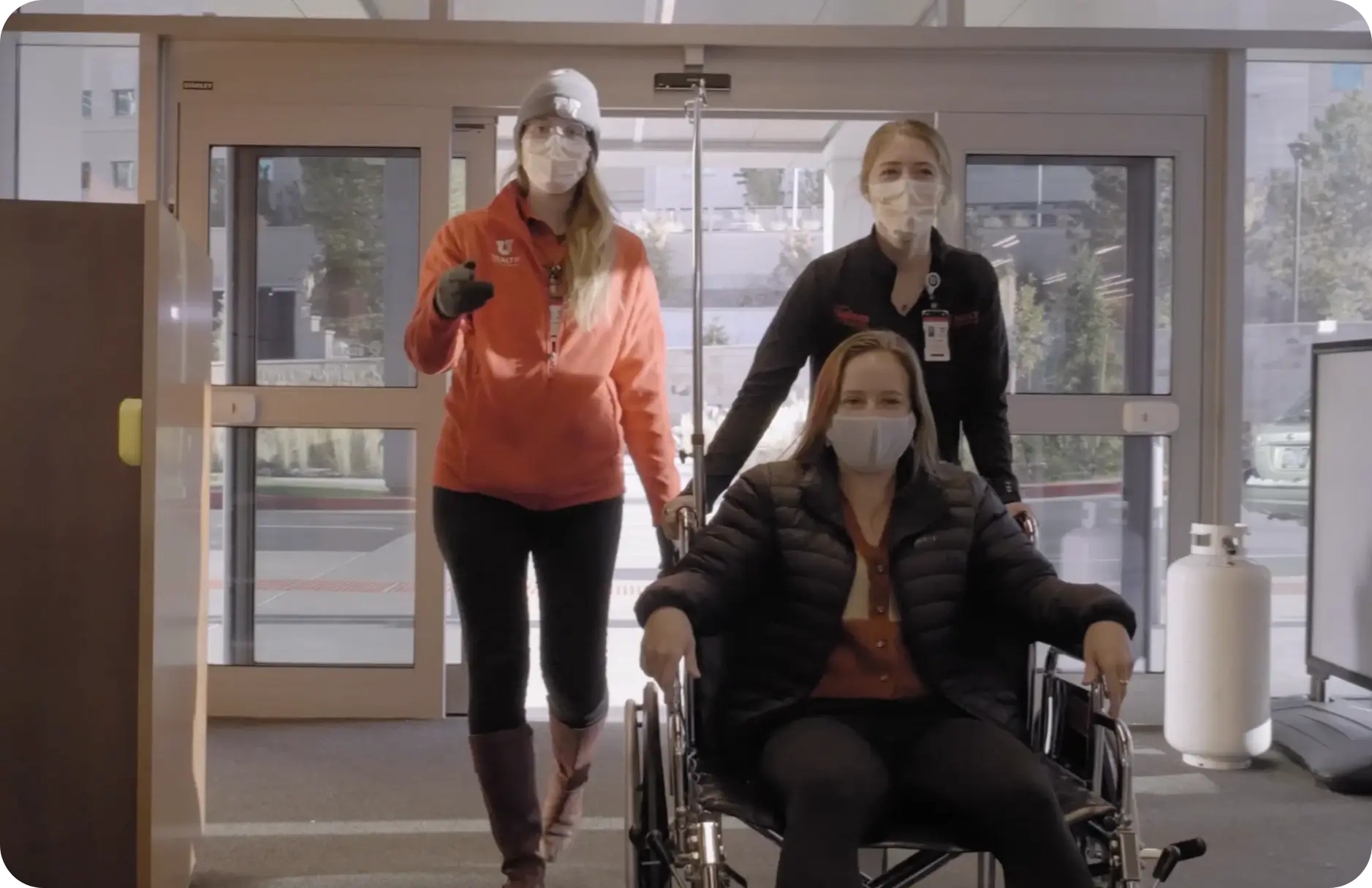 Nurse pushing person in wheel chair