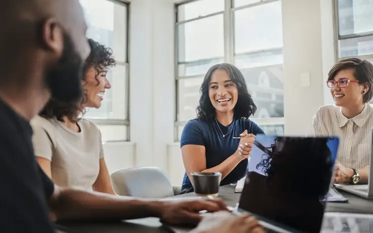people laughing and talking at work