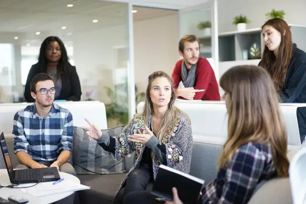 Group of employees having casual meeting in office