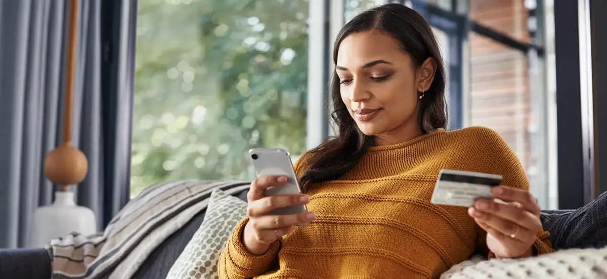 Woman shopping on phone with credit card