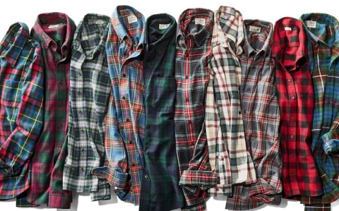 A collection of LL Bean flannel shirts in various plaid patterns and colorways laid out side by side.