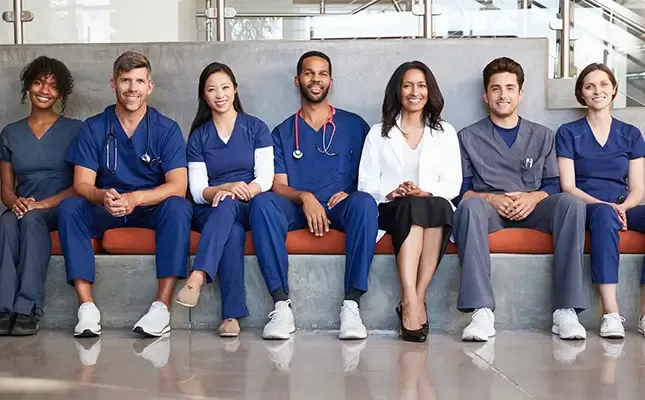 Healthcare workers sitting on a bench