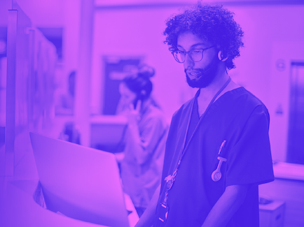 Healthcare worker monitoring a computer