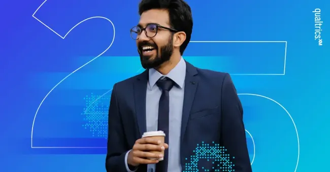 A man smiling while holding a coffee with the number 25 in the background