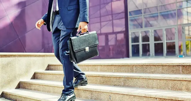man with briefcase walking down steps