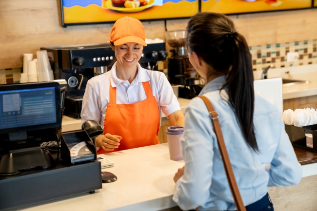 Barista serving a woman buying a coffee