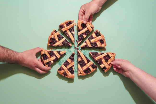 People picking up slices of a pie to demonstrate the concept of segmentation.