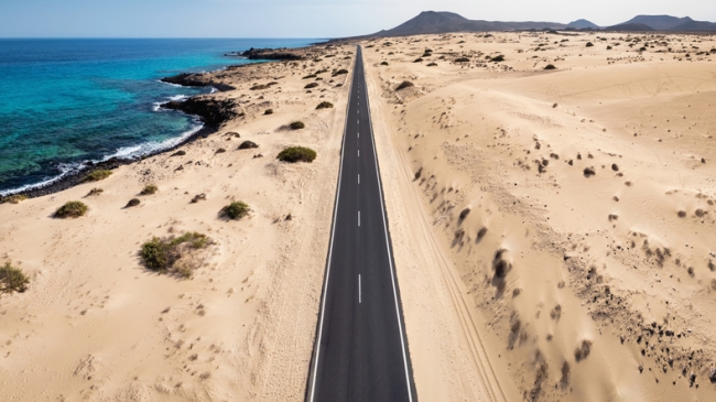 Endless road through  the Corralejo sand dunes in Fuerteventura, Spain.
