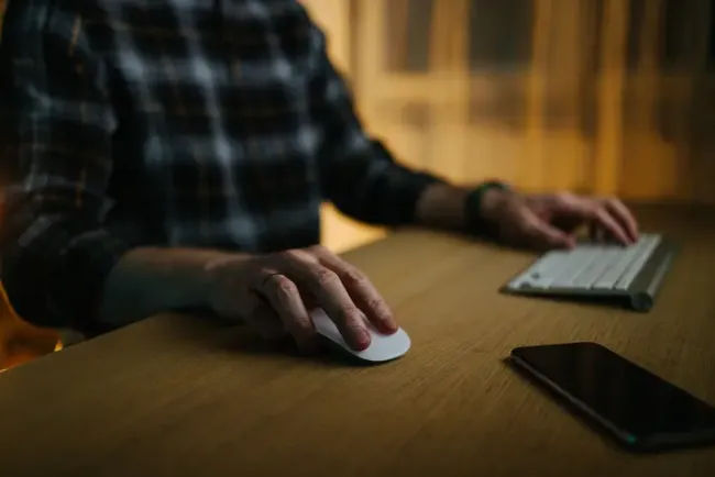 Man using keyboard and mouse at desk