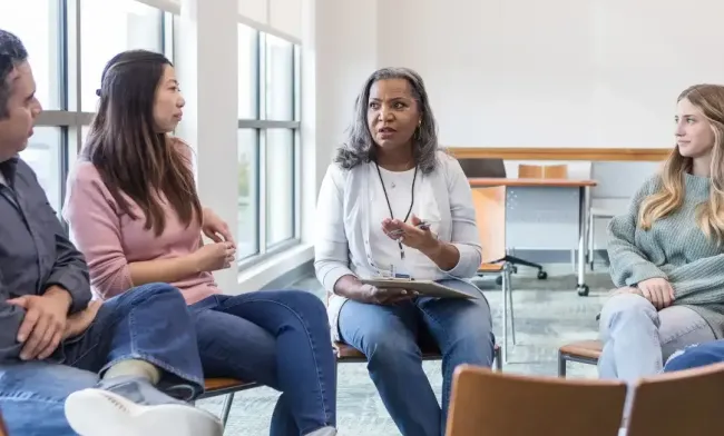 Woman leading a focus group indoors