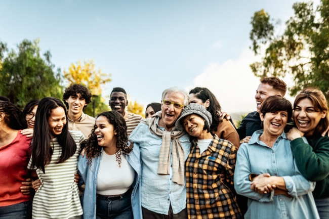 Happy multigenerational people having fun together in a public park.