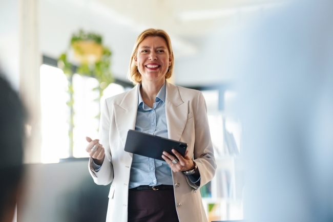 Stock image of a mid-age white woman holding a tablet