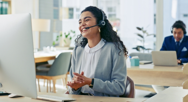 Smiling client service professional at B2B SaaS company.