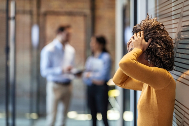 Stressed female employee suffering from disparate treatment.