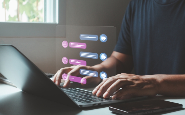 Man using laptop with futuristic chatbot showing real-time conversation between user and AI virtual assistant.