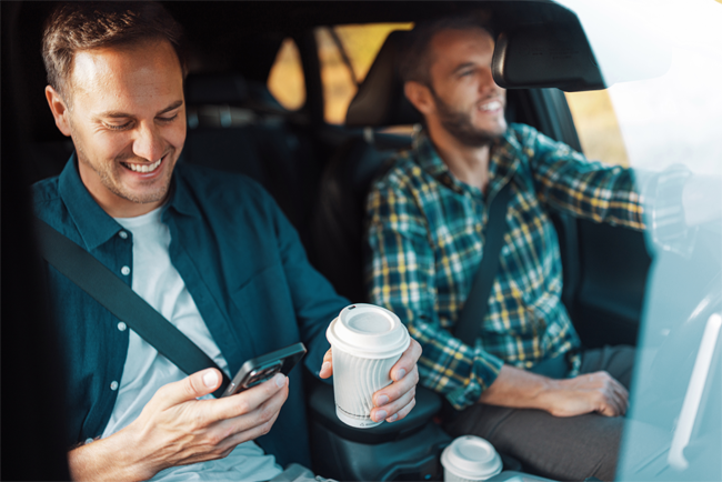 Two adult males riding in a car