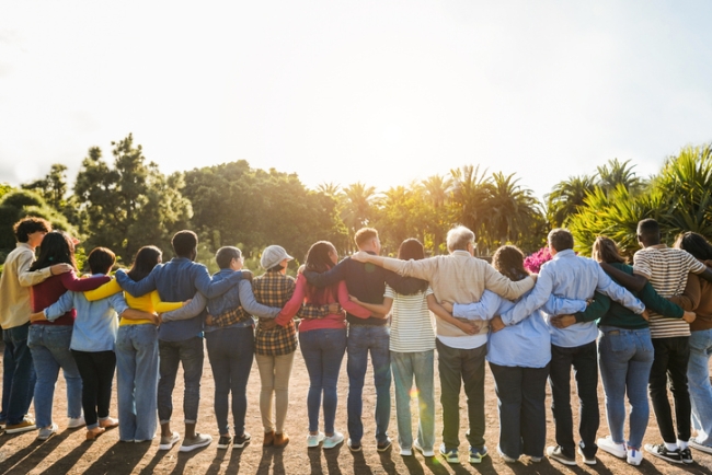  Group of multigenerational citizens hugging each other.