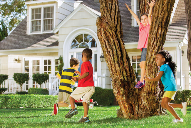 Kids playing outside on the lawn