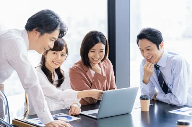 People huddled around a computer
