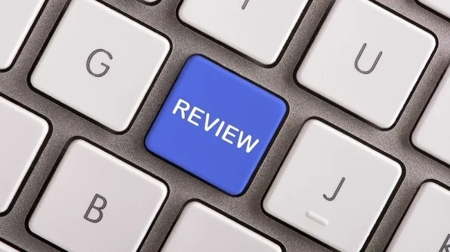 Computer keyboard with a blue keyboard button that says "Review"