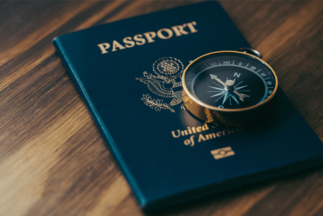 U.S. passport with a compass on top.