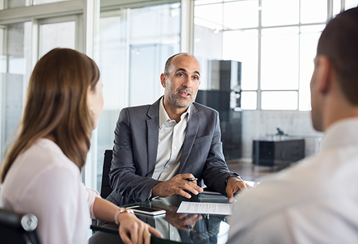 Employees talking together at a team meeting.