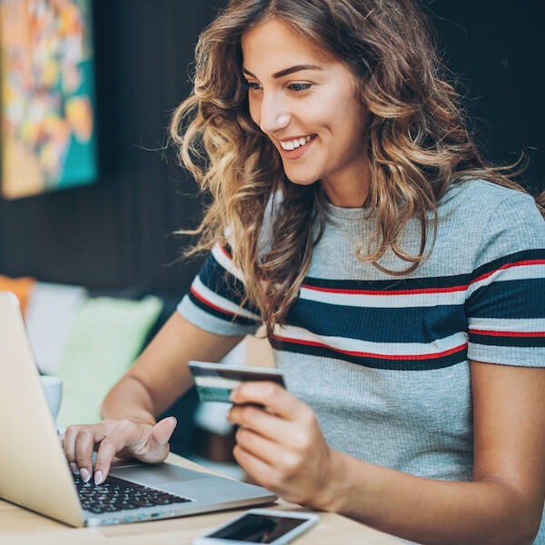 A smiling woman purchasing something online