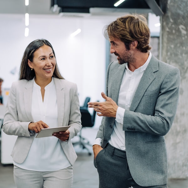 Leader and employee smiling while talking