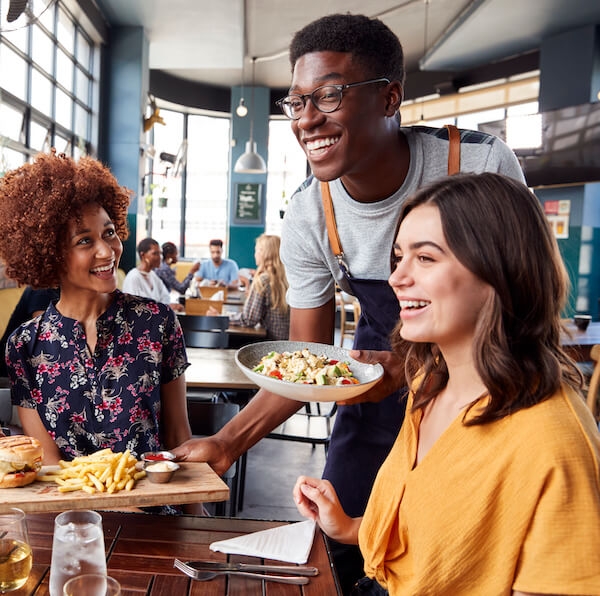 Waiter providing excellent customer service as a customer retention strategy