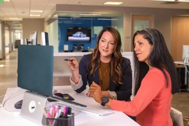 Two women looking at laptop