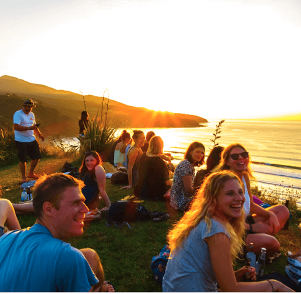 employees happily sitting on a beach