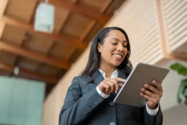 Government employee outside government building looking at tablet