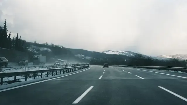 Lone car driving on road